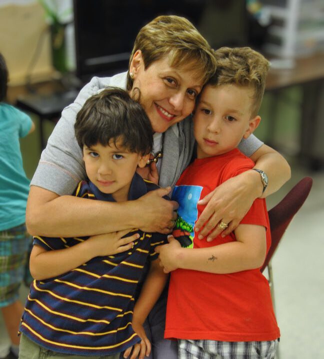 Monart offers art classes in Ottawa for kids, teens, and adults in our vibrant studio. Photo of instructor Vicky Collins with 2 students